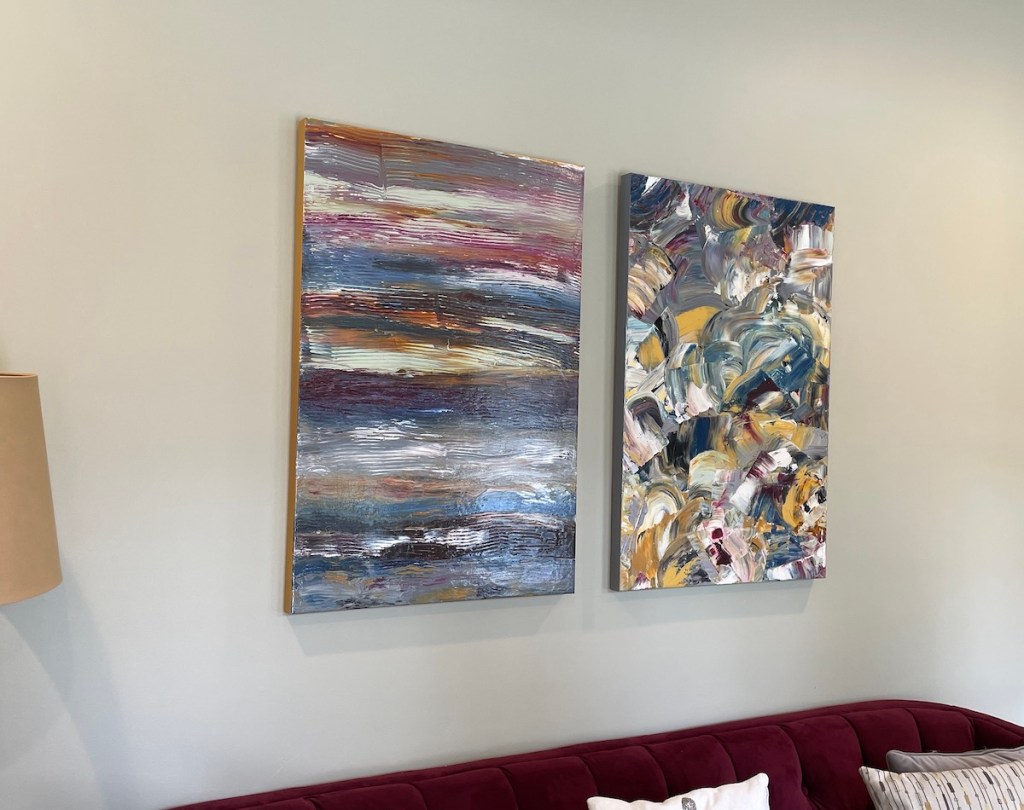 Different view of finished abstract paintings from large scale commission hung over sofa.